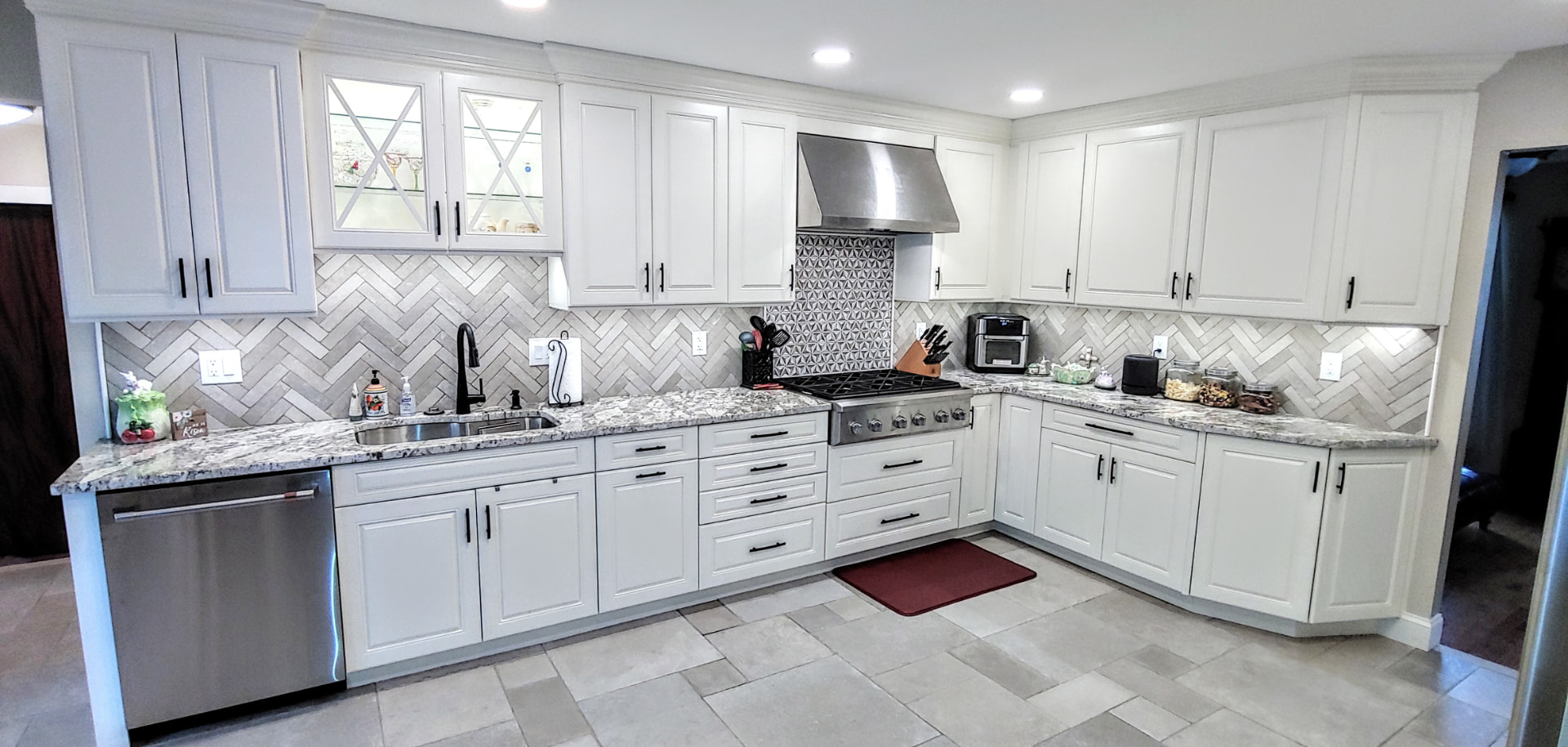 White shaker kitchen with herringbone backsplash