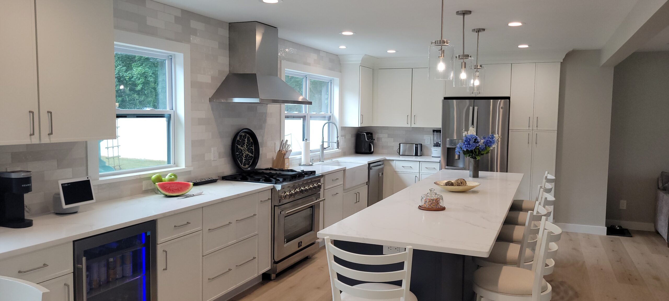 A South Jersey kitchen with white shaker cabinets and a soft blue island