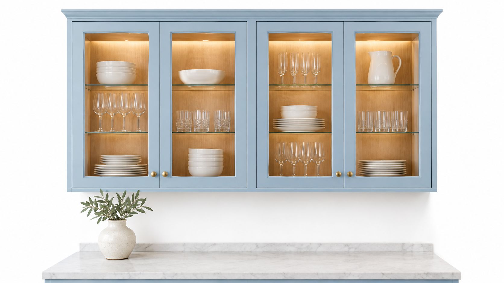 A modern light blue kitchen cabinet with glass doors mounted above a white marble countertop.